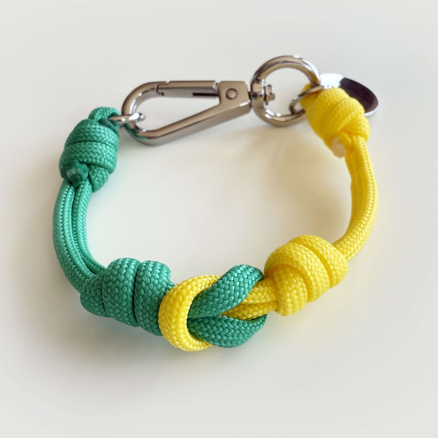 Mapo cord bracelet in beach color with durable nylon cord and metal details.