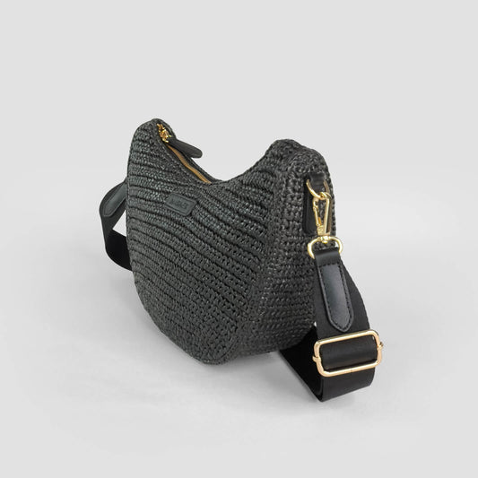 Black woven crocheted handbag with gold accents on a light gray background