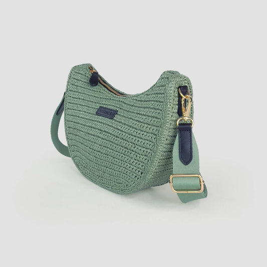 Green crochet bag with gold buckle on a light gray background