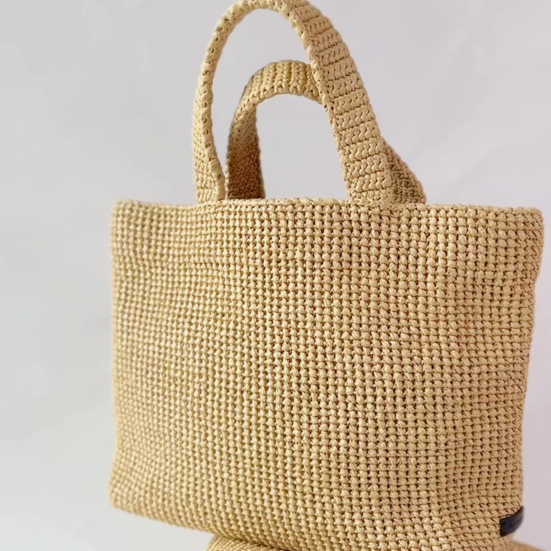 Handmade crochet tote bag made from recycled materials.